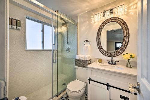 a bathroom with a shower and a toilet and a mirror at Bay Shore Vacation Rental about 7 Mi to the Beach in Bay Shore