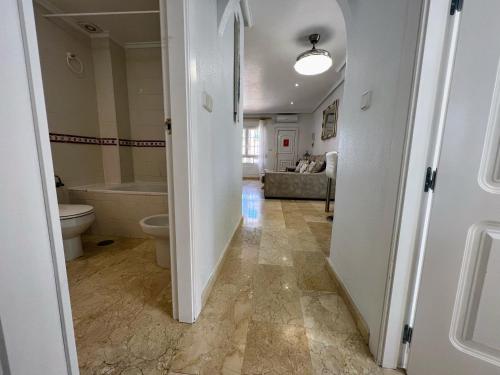 Un pasillo de un baño con bañera y inodoro. en Nice Ground Floor Apartment with Communal Pool in Los Dolses LD279, en Orihuela