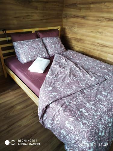a bedroom with a bed with purple sheets and pillows at Herman View Apartment in Grudziądz