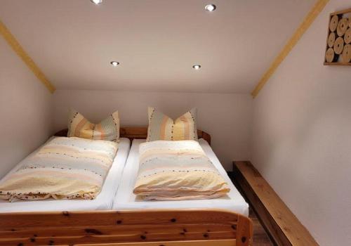 a bedroom with two beds in a small room at Ferien- und Freizeithof Bindl in Sankt Englmar