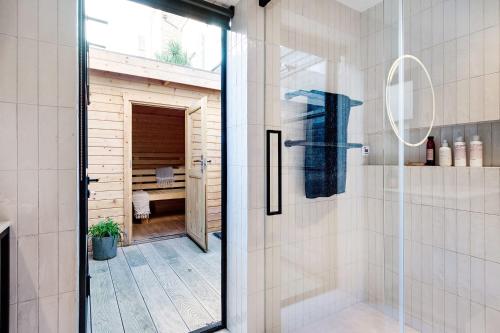 a bathroom with a shower with a glass door at Notting Hill Playhouse in London