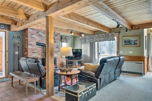 a living room with leather chairs and a table at Cozy Conway Area Home about 4 Mi to Cranmore Mountain! in Intervale