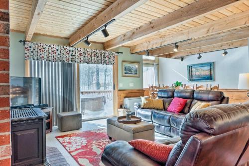 a living room with leather furniture and a fireplace at Cozy Conway Area Home about 4 Mi to Cranmore Mountain! in Intervale