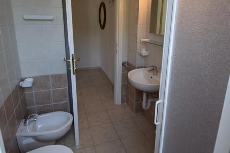a bathroom with a toilet and a sink at Appartamenti Villa Miramare in Capoliveri