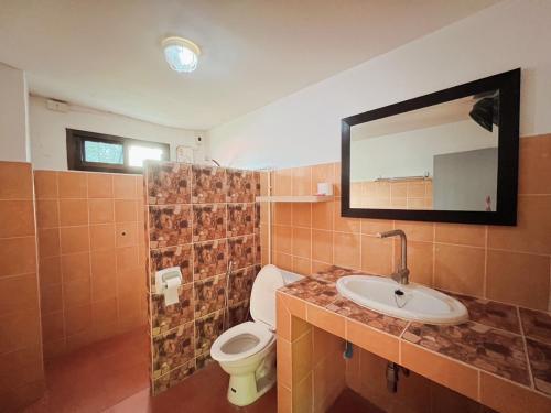 a bathroom with a toilet and a sink and a mirror at Aree Resort in Ban Bang Bao