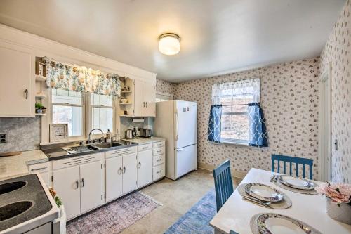 a kitchen with a table and a white refrigerator at Pet-Friendly Mohnton House Near Golf Course! in Mohnton