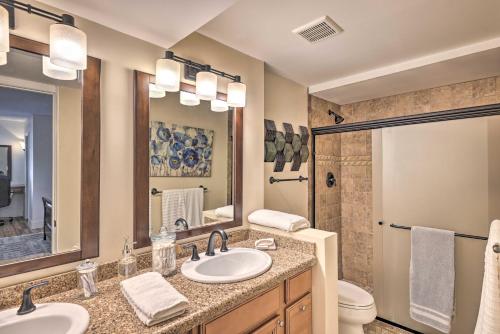 a bathroom with a sink and a toilet and a mirror at Scottsdale Resort Condo Near Old Town! in Scottsdale