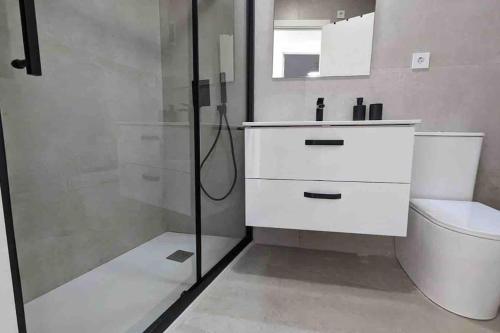 a bathroom with a shower and a sink and a toilet at Centro Plaza Sardoy in Murcia