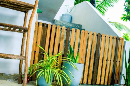 a wooden fence with a potted plant in front of it at Light Moon Villa in Ahangama