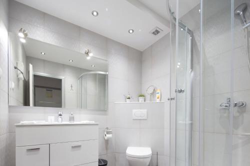 a bathroom with a shower and a toilet and a sink at Villa Nena in Makarska