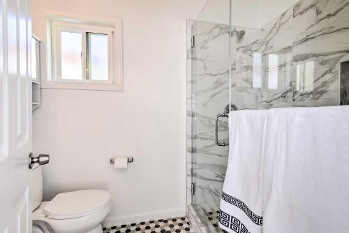 a white bathroom with a toilet and a shower at Chatsworth Studio with Tennis Court Access! in Chatsworth