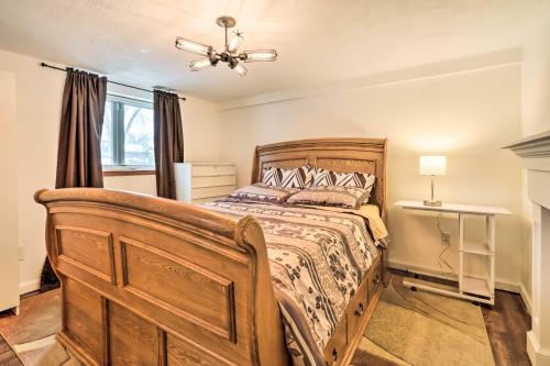 een slaapkamer met een houten bed en een raam bij Pet-Friendly Apartment in Minneapolis! in Minneapolis