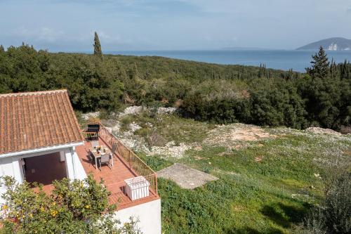 an aerial view of a house and the ocean at Salty Pebble House in Fiskardho
