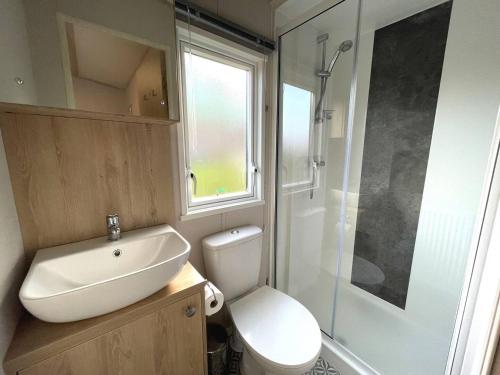 a bathroom with a toilet and a sink and a shower at Pass the Keys Beautiful 2BR In Kippford With Incredible Views in Palnackie