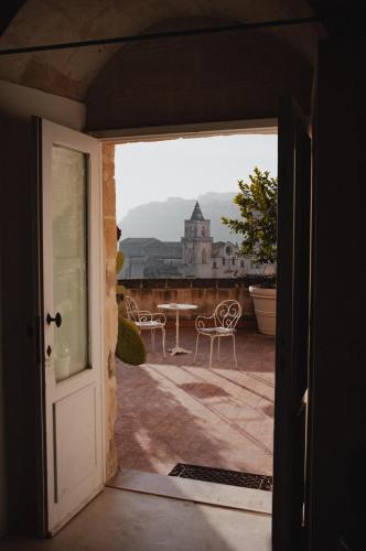 an open door to a patio with a table and chairs at Sant'Angelo, Matera - Small Luxury Hotels in Matera