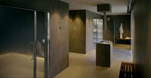 a bathroom with a shower with a glass door at Gallia Palace Hotel - Relais & Châteaux in Punta Ala
