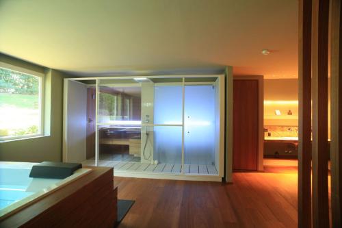 a bathroom with a glass shower in a room at Gallia Palace Hotel - Relais & Châteaux in Punta Ala