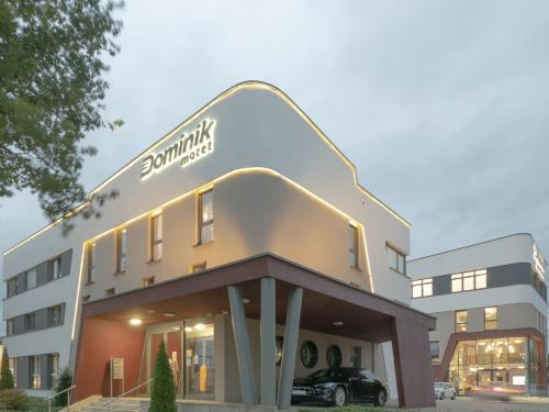a building with a car parked in front of it at Dominik Hotel & Eventsaal in Paderborn
