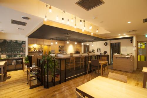 a restaurant with a bar and some tables and chairs at Business Inn Norte 2 in Sapporo