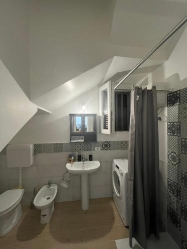 a white bathroom with a sink and a toilet at Holiday Sicily “S&M” in Ficarazzi