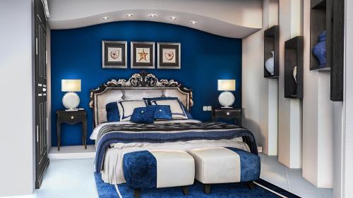 a blue bedroom with a king sized bed with a blue wall at Hotel Onda Verde in Praiano