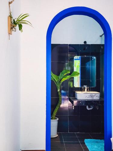 a bathroom with a sink and a potted plant at Dragon Sea Homestay in Hoi An