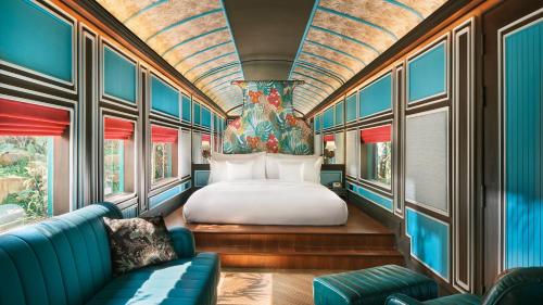 a train room with a bed and a couch at InterContinental Khao Yai Resort, an IHG Hotel in Mu Si