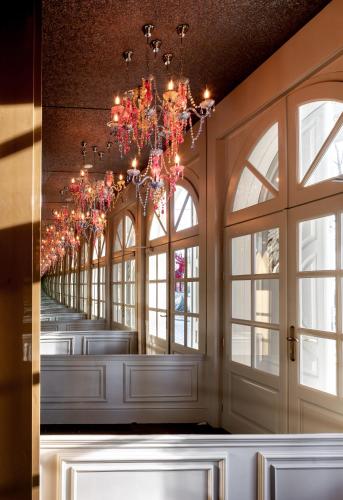 a long hallway with windows and a chandelier at AURORA Tarnów in Tarnów