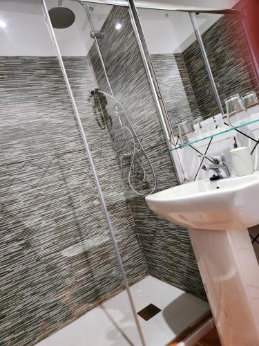 a bathroom with a sink and a shower at Posada La Plaza in Canillas de Albaida