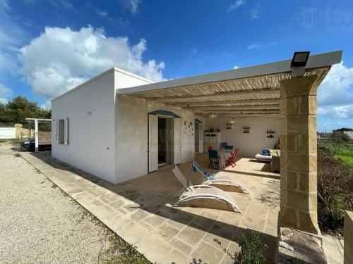 a modern white house with a patio at Gold Beach House by LoveSud in Torre Pali 