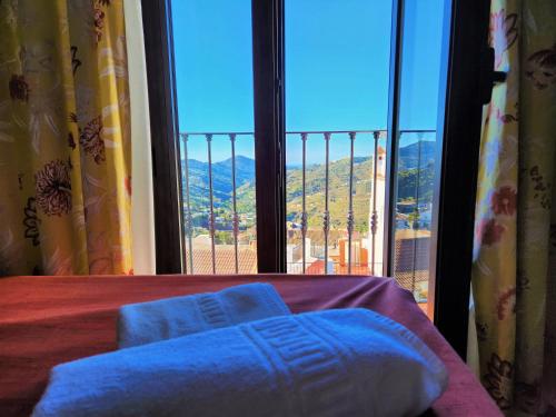 a room with a large window with a blue towel at Posada La Plaza in Canillas de Albaida