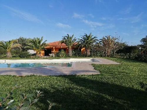 a house with a swimming pool in a yard at Agriturismo Isidoro in Fertilia