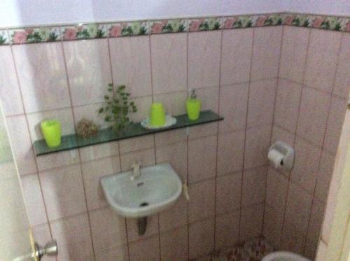 a bathroom with a sink and a toilet at Center Parkway Pension House in Kalibo