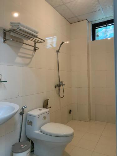 a bathroom with a toilet and a shower and a sink at Ngọc Sinh Homestay in Hoi An