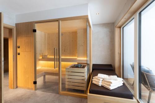 a walk in shower with a bench in a room at BergLeben Zaglauhof in Werfenweng