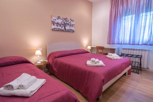 a bedroom with two beds with towels on them at Casa Lighea Mondello in Mondello