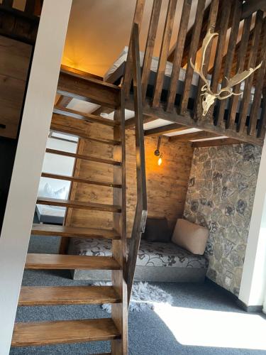 a wooden staircase leading up to a bedroom in a house at Appartement Sabrina in Steinberg am Rofan