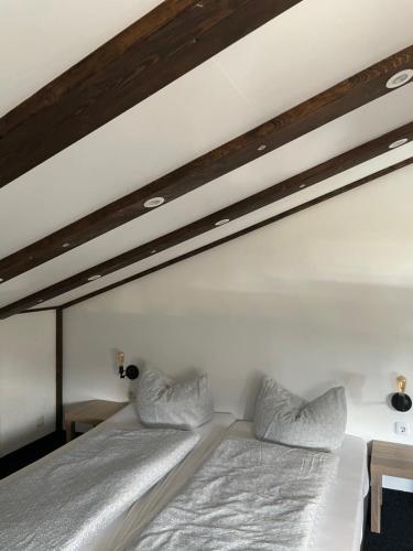 a bed with two pillows on top of it at Appartement Sabrina in Steinberg am Rofan