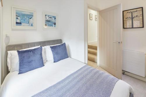 a bedroom with a large bed with blue pillows at Host & Stay - Number 2 at Pannett Apartments in Whitby