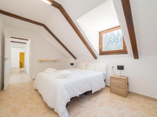um quarto branco com uma cama branca e uma janela em Cubo's Villa Garden em Alhaurín el Grande