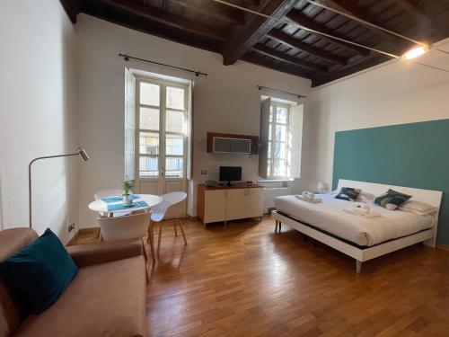 ein Schlafzimmer mit einem Bett und ein Wohnzimmer in der Unterkunft Le Petit Loft - Piazza San Carlo in Turin