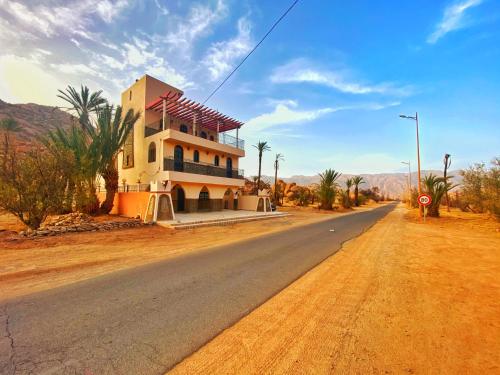 a house on the side of a road in the desert at Dar izem in Tafraoute