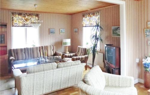 a living room with chairs and a couch and a tv at Holiday Home Lertagsvägen Mörbylånga in Mörbylånga