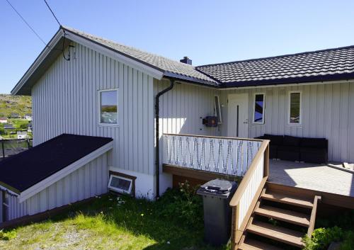a small house with a porch and a deck at Havøysund house with a beautiful view in Måsøy
