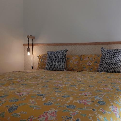 a bedroom with a large bed with a colorful bedspread at La Cultureta in Segura de León