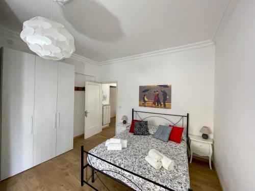 a bedroom with a bed and a chandelier at VILLA ROMANA in Diano Marina