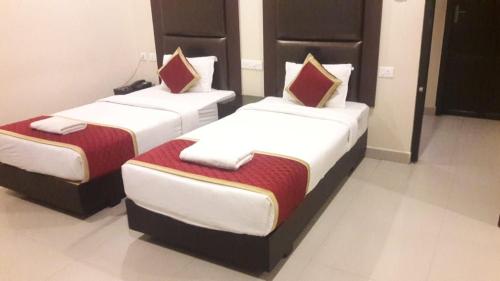 two beds in a hotel room with at HOTEL PIONEER PARADISE in Nāgercoil