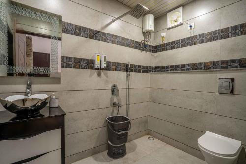 a bathroom with a sink and a toilet at Luxury Farmhouse Stay, Pure Vegetarian- Santushti Farm, NCR in Tibri