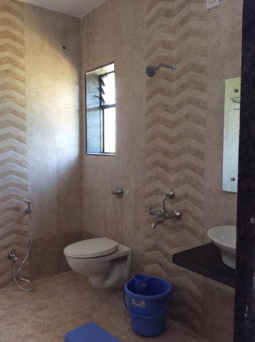 a bathroom with a toilet and a sink at Gugal Residency Mahabaleshwar in Mahabaleshwar