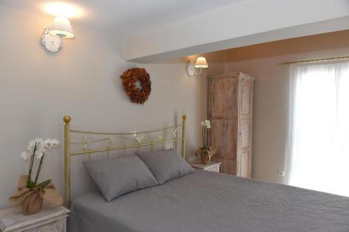 a bedroom with a bed and a window at Oisyra Boutique Suites in Ermoupoli